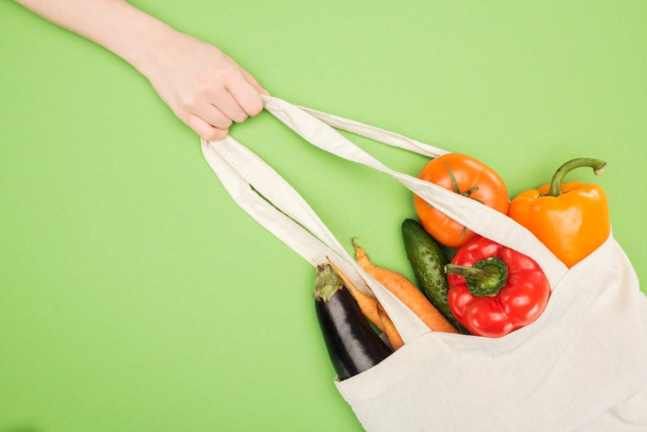 white eco friendly grocery bag in hand