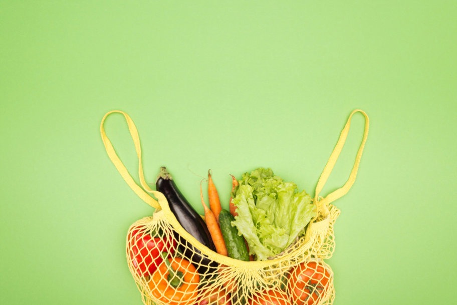 yellow eco friendly grocery bag in hand